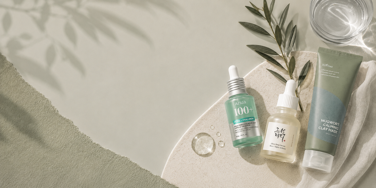 Curated Korean skincare products on a light sage and greige background