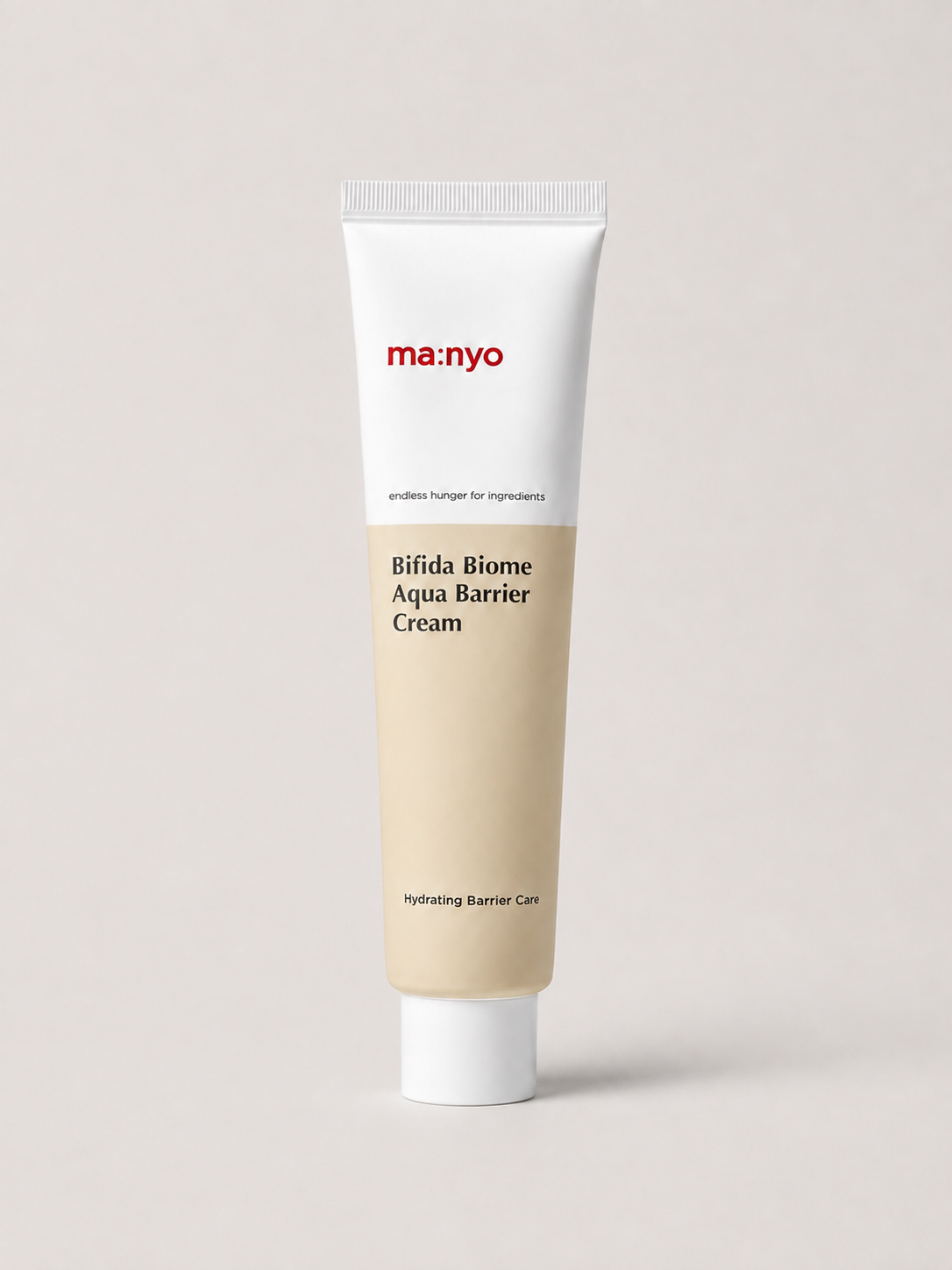 A korean skincare tube of ma:nyo Bifida Biome Aqua Barrier Cream, featuring a white upper section with red brand text and a beige lower section, set against a solid light gray background. 80 ml.
