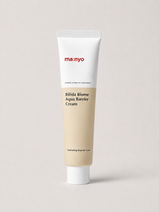 A korean skincare tube of ma:nyo Bifida Biome Aqua Barrier Cream, featuring a white upper section with red brand text and a beige lower section, set against a solid light gray background. 80 ml.
