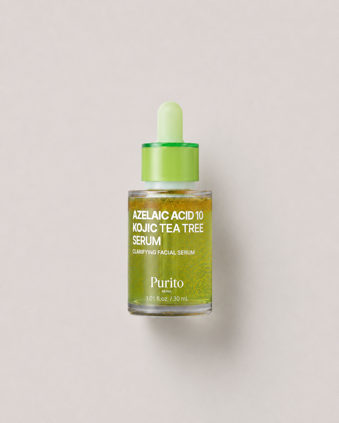 A korean skincare serum - Purito Azelaic Acid 10 Kojic Tea Tree Serum in a clear glass dropper bottle with a bright green cap and dropper, set against a solid light gray background. 30 ml.